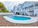 Large kidney-shaped pool in backyard with lounge chairs at 3811 Bayside Cir, Bradenton, FL 34210