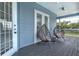 Relaxing covered porch with wicker chairs and French doors at 3811 Bayside Cir, Bradenton, FL 34210