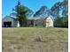 Ranch home on a grassy lot showing side and front porch with garage in view at 27373 Sandrala Dr, Punta Gorda, FL 33955