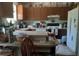 Functional kitchen with a breakfast bar, white appliances, wood cabinets, and lots of natural light at 27373 Sandrala Dr, Punta Gorda, FL 33955