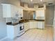 Well-equipped kitchen featuring white cabinets and modern appliances at 1822 Raven Glen Dr, Ruskin, FL 33570