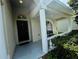 Covered front porch with a bench and decorative columns at 1822 Raven Glen Dr, Ruskin, FL 33570