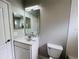 Clean bathroom with single sink vanity, toilet, and mirrored medicine cabinet at 1822 Raven Glen Dr, Ruskin, FL 33570