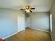 Bedroom with hardwood floors, ceiling fan, and closet at 1822 Raven Glen Dr, Ruskin, FL 33570