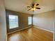 Bright bedroom with hardwood floors, ceiling fan, and window at 1822 Raven Glen Dr, Ruskin, FL 33570