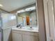 Double vanity bathroom with marble countertop and a walk-in shower at 1822 Raven Glen Dr, Ruskin, FL 33570