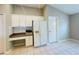 Kitchen with white cabinets, built-in desk, and refrigerator at 1822 Raven Glen Dr, Ruskin, FL 33570