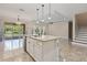 Kitchen island with granite countertop and white cabinets at 2824 Esmeralda Dr, Sarasota, FL 34243