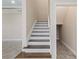 Staircase with dark wood steps and white risers at 2824 Esmeralda Dr, Sarasota, FL 34243