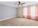 Bright bedroom with neutral carpeting and ceiling fan at 2824 Esmeralda Dr, Sarasota, FL 34243