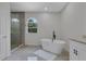 Bathroom featuring a large walk-in shower and a window with a view at 3005 Desoto Rd, Sarasota, FL 34234