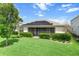 House back view, showcasing solar panels and a large yard at 17861 Wayside Bnd, Punta Gorda, FL 33982