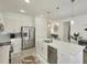 Modern kitchen with white cabinets, stainless steel appliances and island at 5827 Mezzana Run, Palmetto, FL 34221