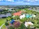 Aerial view of community pool, playground, and surrounding homes at 5827 Mezzana Run, Palmetto, FL 34221