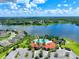 Aerial view of community pool and clubhouse near a lake at 5827 Mezzana Run, Palmetto, FL 34221
