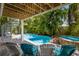 Inviting freeform pool and spa with surrounding patio furniture at 4105 4Th Ave, Holmes Beach, FL 34217