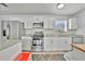 Bright kitchen with white cabinets, stainless steel appliances, and granite counters at 21403 Glendale Ave, Port Charlotte, FL 33952