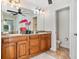 Double vanity bathroom with granite countertops and separate toilet area at 10268 Alexandria Ave, Englewood, FL 34224
