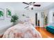 Guest bedroom with hardwood floors, ceiling fan, and adjacent bathroom at 10268 Alexandria Ave, Englewood, FL 34224