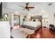 Spacious main bedroom with hardwood floors and access to backyard patio at 10268 Alexandria Ave, Englewood, FL 34224
