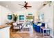 Bright living room featuring a comfy blue sofa and access to the patio at 10268 Alexandria Ave, Englewood, FL 34224