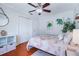 Guest bedroom with hardwood floors, ceiling fan, and adjacent bathroom at 10268 Alexandria Ave, Englewood, FL 34224