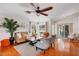 Living room with hardwood floors, a brown couch, and a view of the pool at 10268 Alexandria Ave, Englewood, FL 34224