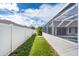 Backyard oasis with a screened-in pool and grassy area at 10268 Alexandria Ave, Englewood, FL 34224