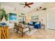 Relaxing living room with a blue couch, and access to the backyard at 10268 Alexandria Ave, Englewood, FL 34224