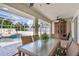 Covered patio with outdoor dining set overlooking the refreshing pool at 10268 Alexandria Ave, Englewood, FL 34224