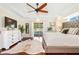 Main bedroom with hardwood floors, pool view, and walk-in closet at 10268 Alexandria Ave, Englewood, FL 34224
