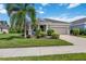 Single-story house with a two-car garage and palm trees at 164 Avens Dr, Nokomis, FL 34275