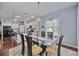 Bright dining room with glass table, neutral decor, and hardwood floors at 164 Avens Dr, Nokomis, FL 34275
