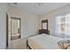 Bedroom with a queen bed, en-suite bathroom access, and a dresser at 164 Avens Dr, Nokomis, FL 34275
