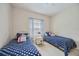 Bright bedroom with twin beds and blue polka dot bedding at 164 Avens Dr, Nokomis, FL 34275