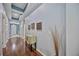 Light and bright hallway with wood flooring and recessed lighting at 164 Avens Dr, Nokomis, FL 34275