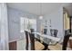 Bright dining room with glass table, neutral decor, and hardwood floors at 164 Avens Dr, Nokomis, FL 34275