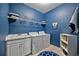 Laundry room with washer, dryer, and white cabinets at 164 Avens Dr, Nokomis, FL 34275