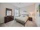 Bedroom with a queen bed, dark wood dresser and nightstand at 164 Avens Dr, Nokomis, FL 34275