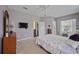 Bright bedroom with a flat-screen TV, built-in dresser and ensuite access at 164 Avens Dr, Nokomis, FL 34275