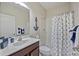 Clean bathroom with navy and white decor, shower, and a white vanity at 164 Avens Dr, Nokomis, FL 34275