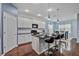 Modern kitchen with white cabinets, breakfast bar, and dark countertops at 164 Avens Dr, Nokomis, FL 34275