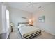 Bedroom with a queen bed, dark wood dresser, and coastal decor at 164 Avens Dr, Nokomis, FL 34275