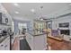 Open concept kitchen with island, stainless steel appliances, and dark countertops at 164 Avens Dr, Nokomis, FL 34275