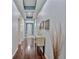 Spacious hallway featuring wood floors and a decorative console table at 164 Avens Dr, Nokomis, FL 34275