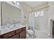 Clean bathroom with tub, shower, and dark wood vanity at 164 Avens Dr, Nokomis, FL 34275