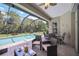 Relaxing screened pool area with patio furniture, offering ample space for outdoor enjoyment at 164 Avens Dr, Nokomis, FL 34275