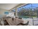 Covered patio with wicker furniture, dining table, and view of the pool at 10346 Morning Mist Ln, Sarasota, FL 34241