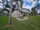 Tan house exterior, landscaping, and stone pathway at 2631 Fiesta Dr, Venice, FL 34293