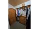Walk-in closet with wood armoire and dresser at 2631 Fiesta Dr, Venice, FL 34293